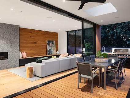 Open-concept living and dining area with sliding glass doors and modern décor