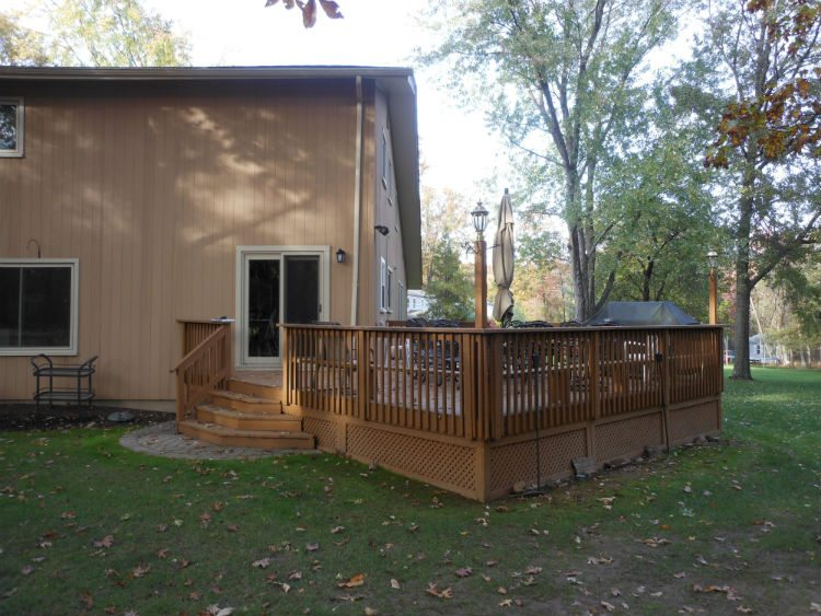 Backyard wooden deck attached to single-family home