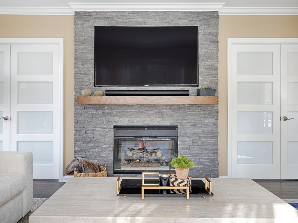 Stone fireplace with mounted TV and modern living room decor