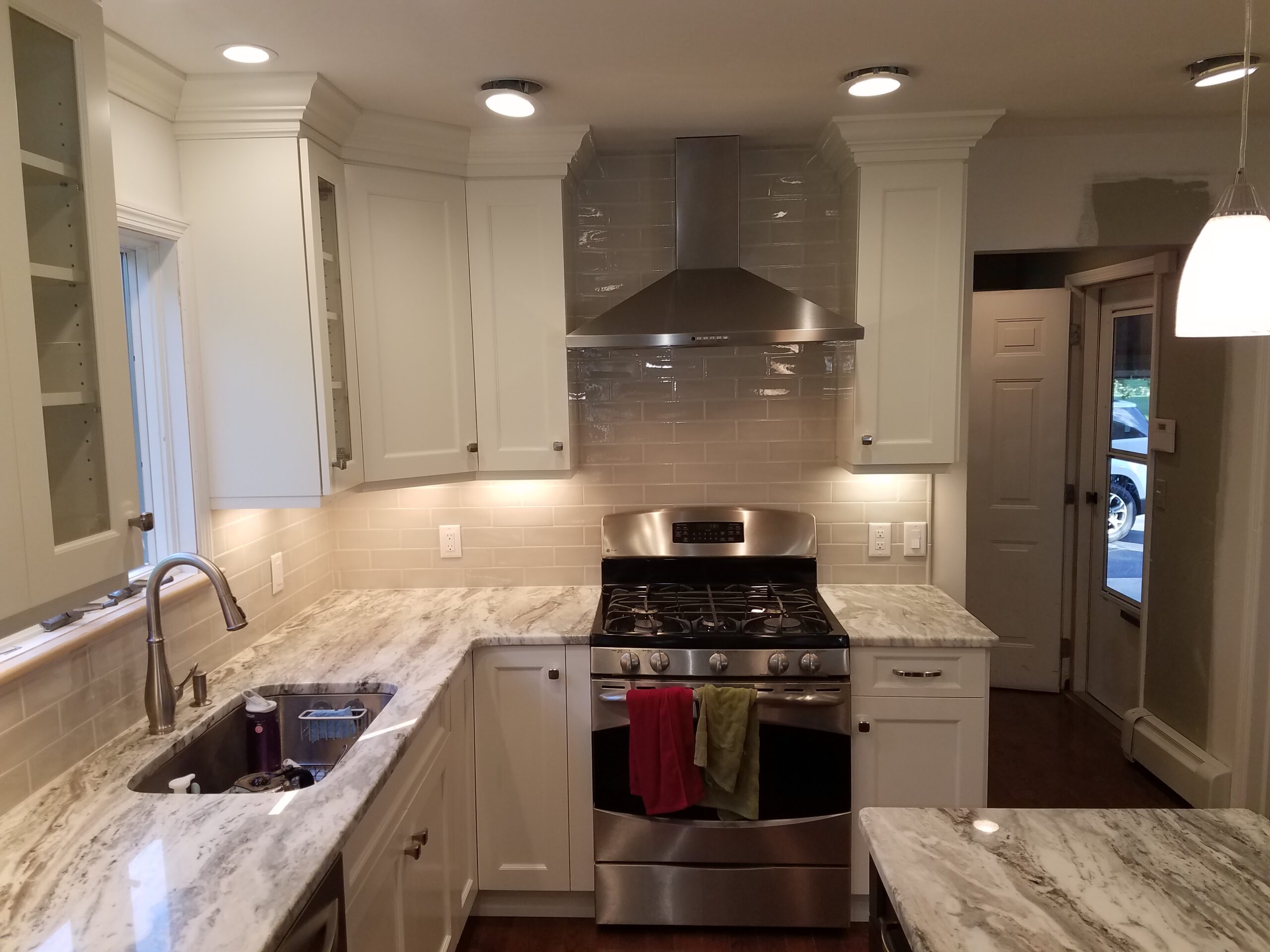 White kitchen design with ample counter space and under-cabinet lighting