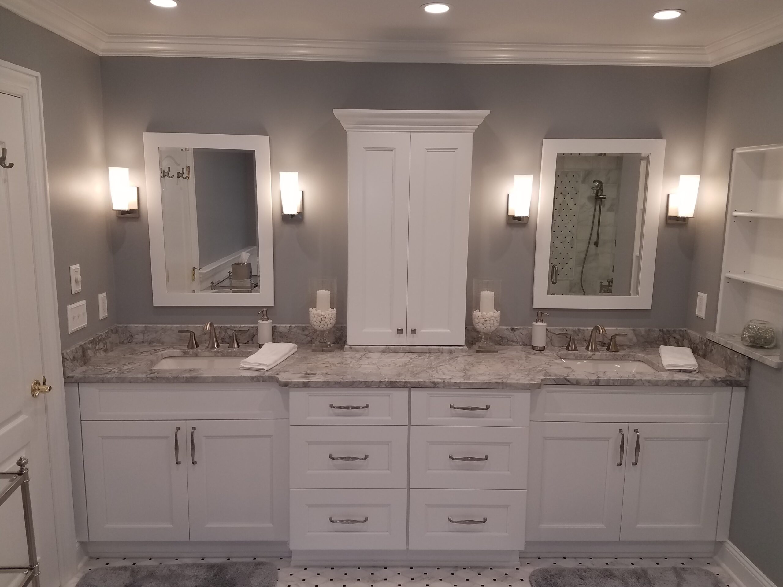 Bathroom renovation with white vanity and dual mirrors