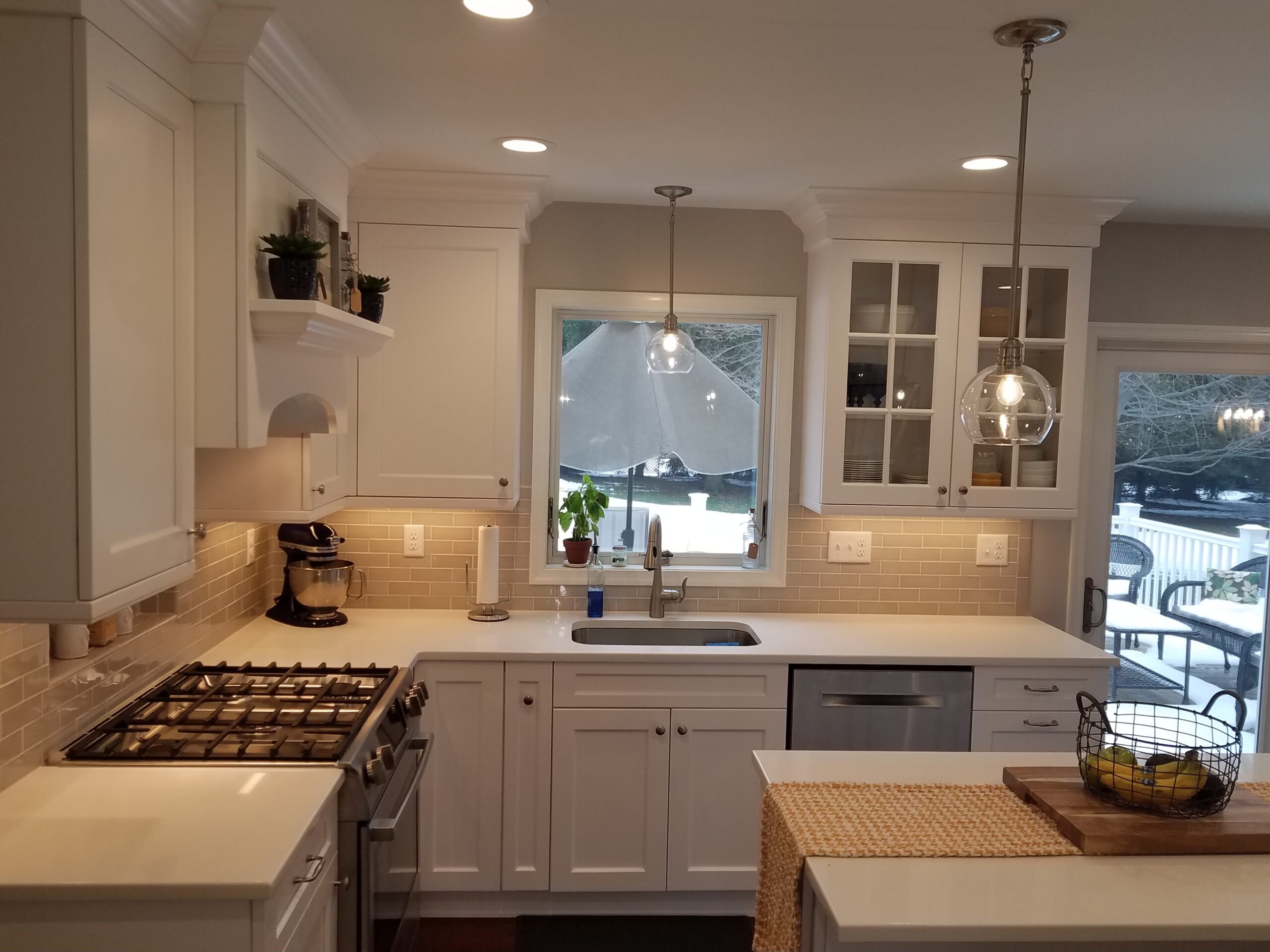 Bright kitchen with white cabinetry and stainless steel appliances