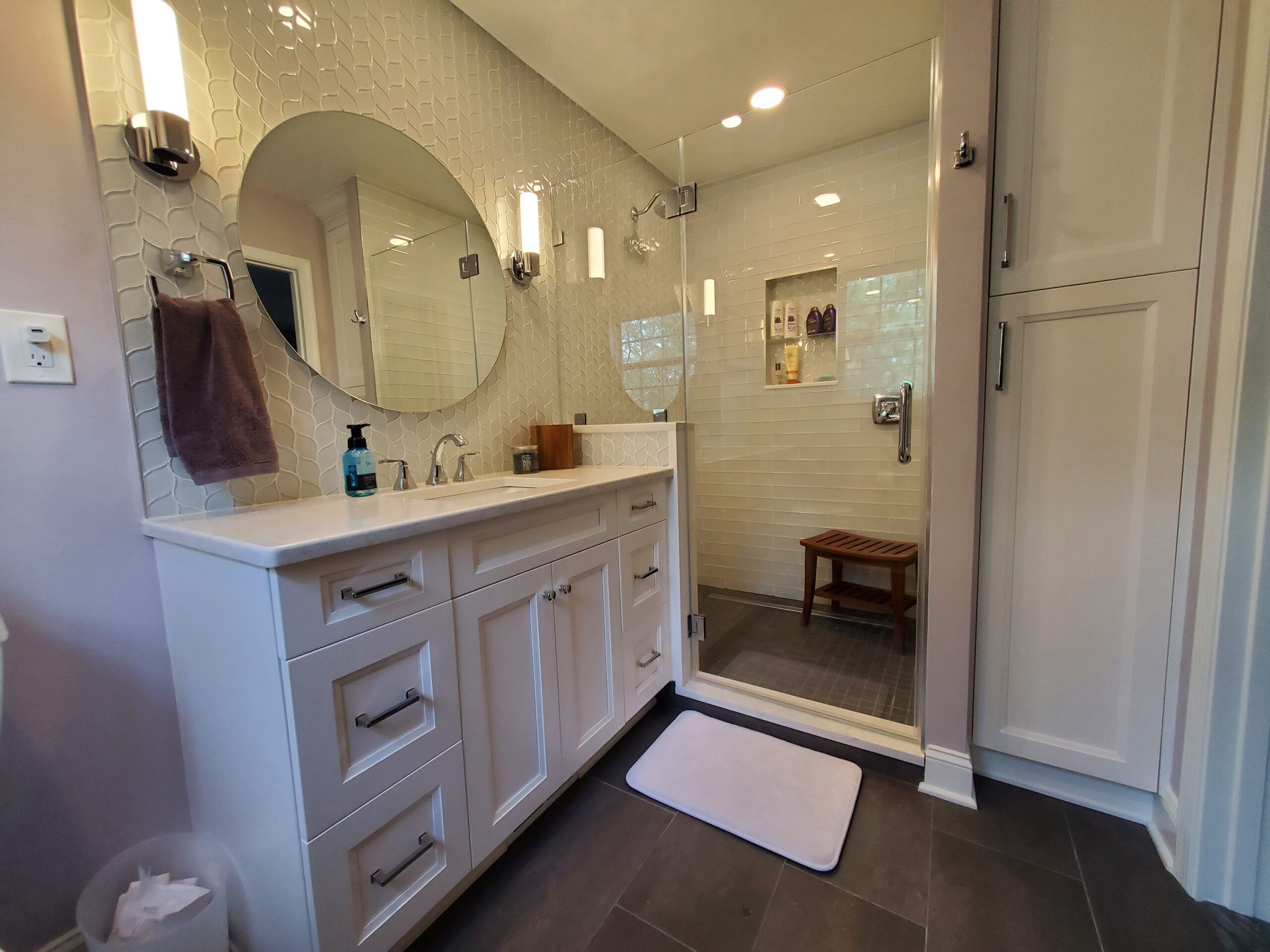 Modern white bathroom with dual mirrors and marble countertop